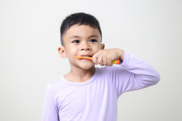 child Asia kid boy brushing teeth isolated on white backgroud.