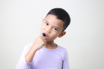 child Asia kid boy brushing teeth isolated on white backgroud.
