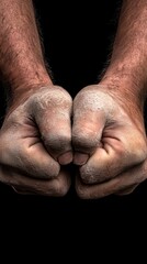 Fototapeta premium A close-up of two clenched fists, showcasing strength and determination against a dark background, perfect for fitness or motivation themes.