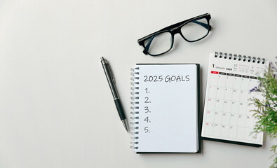 2025 New Year goal, plan, and action concepts. 2025 goals Text on Note Pad with calendar, glasses...