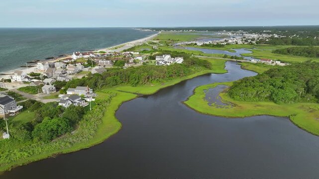 Picturesque Cape Cod waterfront neighborhood, nestled between Atlantic ocean and vibrant green marshland