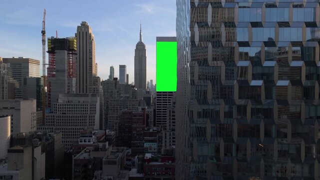AERIAL: Greenscreen billboard render on a building in middle of Midtown, New York