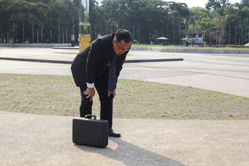 Asian Young Businessman Feeling Tired After Long Day At Work