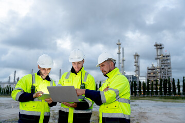 Wide shot factory engineer or technician workers with one hold laptop and other hold tablet also...
