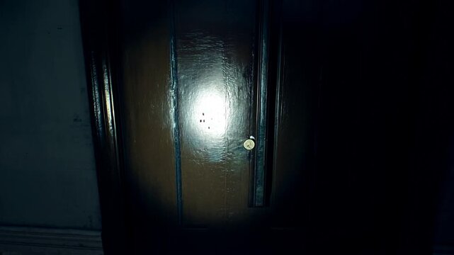 Mysterious wooden door exploration at an abandoned house at night