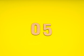 Number zero five in leather on yellow background