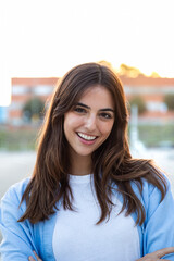 Vertical portrait of happy confident young woman outdoors looking at camera looking at camera.