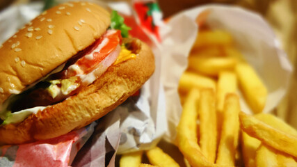 Delicious and high calorie fast food: a hamburger and french fries