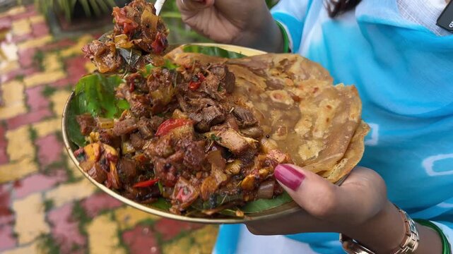 Close up shot of Sukha mutton and paratha.