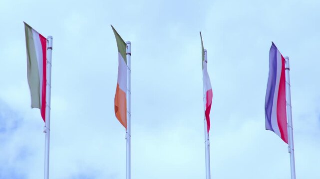 national flags Europe and other countries on satin flutter in wind in blue sky, European Space Agency, state symbols, concept of international cooperation, global business
