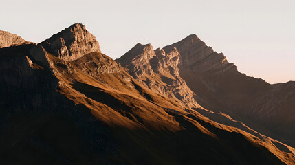 Naklejka premium A sweeping panoramic scene of a mountain range at dawn, where the peaks progressively come into view under the warm light, emphasizing the textures and intricate details of the rocky terrain.