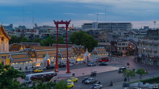 Time lapse of The Giant Swing or Sao Ching Cha monument with Wat Suthat temple at night in old town, Bangkok City, Thailand. Landmark tourist attraction. Thai architecture with travel trip concept.