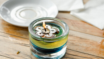 Scented candles on the dining table which also works to keep flies away. Scented handmade candles. Burning soy candles