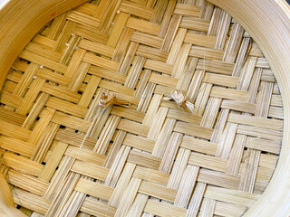 woven bamboo texture. bamboo weave plate on wooden background