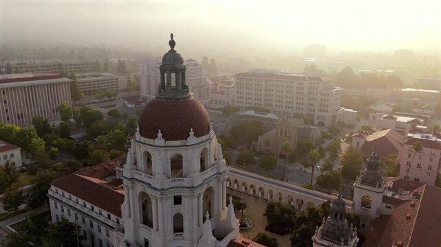 This breathtaking aerial view captures Pasadena City Hall in all its glory, showcasing the iconic architecture and the beautiful surrounding cityscape, all set against a misty and enchanting backdrop