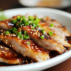 A close-up shot of a beautifully plated dish of grilled pork slices finely chopped green onions and sprinkled with white sesame seeds