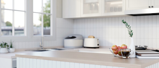 A wood kitchen island countertop in a modern minimalist white kitchen.