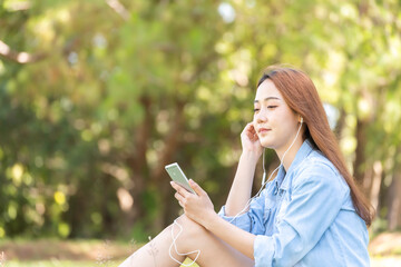 Women with mobile phones and tablets in the beautiful backyard.