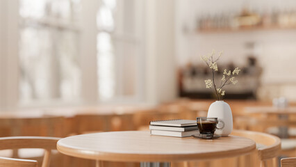 A space for displaying products on a round wooden table in a cozy contemporary coffee shop.