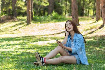 Women with mobile phones and tablets in the beautiful backyard.