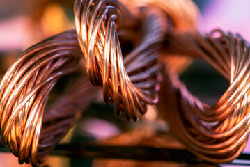 Copper wire closeup on toned colorful background, raw material for industry