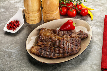 Grilled chuck roll steak with arugula