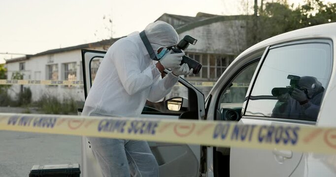 Forensic photographer, person and car with crime in street for inspection, hijacking and evidence for police. Man, camera and road with investigation, accident or ppe suit by stolen vehicle in Sydney