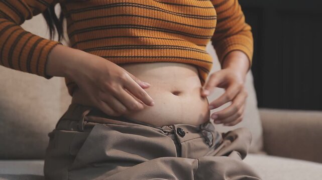 fat woman, fat belly, chubby, obese woman hand holding excessive belly fat with measure tape, woman diet lifestyle concept