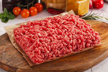 Raw minced beef meat over board