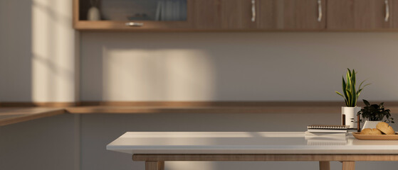 Fototapeta premium A copy space for displaying products on a white kitchen table in a contemporary, minimalist kitchen.