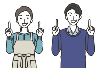 上を指さす40代か50代の男性と女性