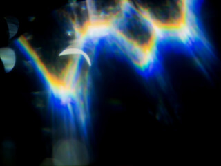 Light leaks on dark background. The colors and shapes create a sense of movement and energy. Optical effect.