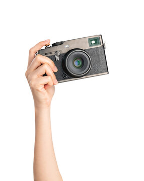 hand holding vintage camera on isolated white background.