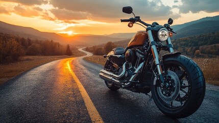 Motorcycle standing on winding road at sunset in autumn