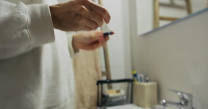 Woman checking pregnancy test taking it, closeup shot, Anxiety or worried woman waiting for results from pregnancy testing kit
