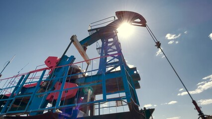 oil production a business lifestyle. silhouette of an oil and gas drilling rig in the sunset glare....