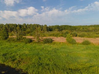 Fototapeta premium Panorama view from above of a summer landscape. Agriculture, green fields