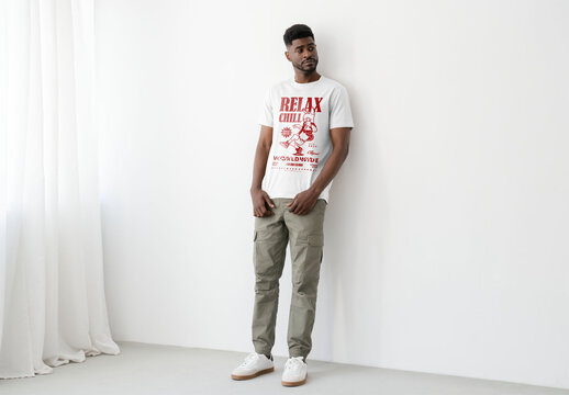 Mockup Of Man In Customizable T-Shirt Against Wall, Full Length