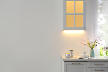 Stylish kitchen interior with white wall. Space for text