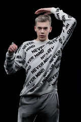 Young man posing in the dark in the studio