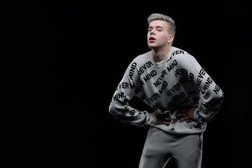 Young man posing in the dark in the studio