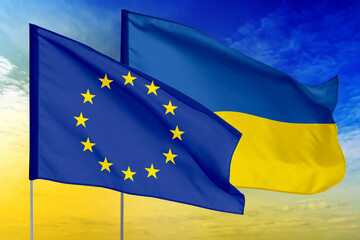 Flags of European Union and Ukraine against sky. Diplomatic international relations
