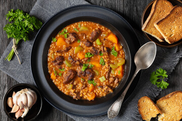 beef barley soup in a bowl, top view