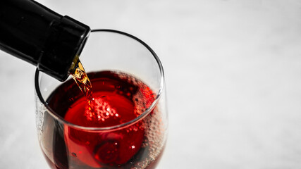 red wine pouring into glass, close up, bokeh, motion blur