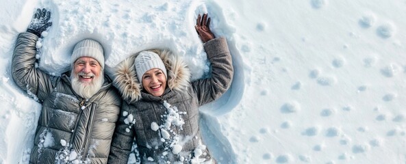 Winter senior couple making snow angel. Happy old woman and man. Mature family laying outside. Cold people, active fun and walk on winter holiday. Elderly couple on nature. Healthy sport relax banner