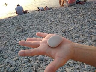pebbles on the palm at sunset