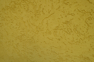 Front view of yellow wall with stucco worm finish