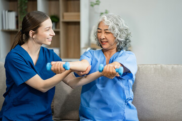 senior woman doing exercise at clinic with physiotherapist. help of a personal trainer during a rehabilitation session.