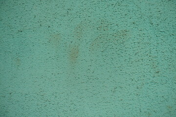 Macro of old an d dirty pale turquoise painted wall