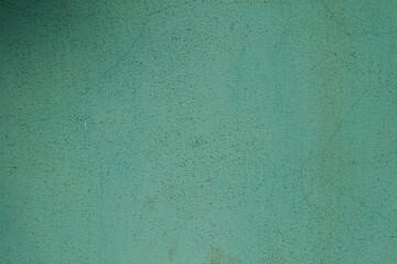 Surface of dirty and faded turquoise painted wall